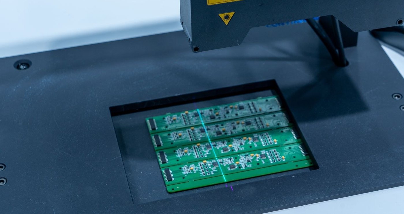 Assembled PCB panel on an automated inspection machine — BoardTech turnkey production support